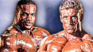 Thumbnail image for the video "Dorian Yates ATTACKED Chris Cormier (MUST SEE)" from the channel Bodybuilding Legends, featuring a dramatic split-screen with Dorian Yates on the left, flexing his muscles with an intense expression, and Chris Cormier on the right, looking surprised and defensive, set against a bold, eye-catching background with the video's title in large, striking font.