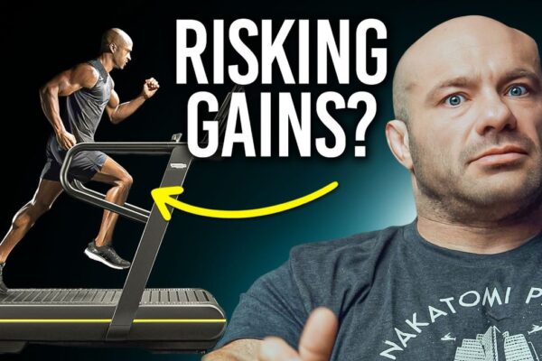 Thumbnail image for the video "Does Cardio After Lifting Kill Your Gains?" from Renaissance Periodization channel: A muscular man in a gym setting, looking confused while holding a dumbbell in one hand and a treadmill handle in the other, with bold text overlay questioning the impact of cardio on muscle gains.